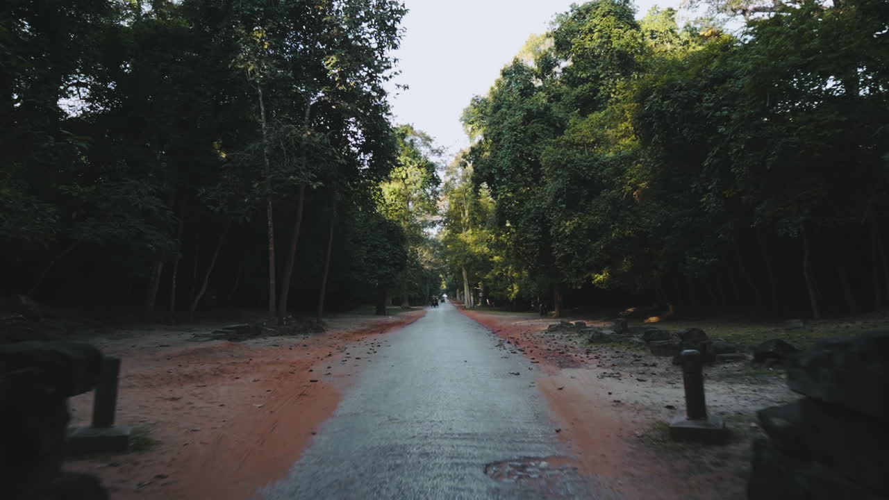 First person view riding a motorcycle entering through Victory Gate, Angkor Wat Thom Cambodia