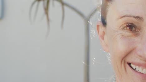 portrait close up of unaltered senior caucasian woman smiling, slow motion, with copy space