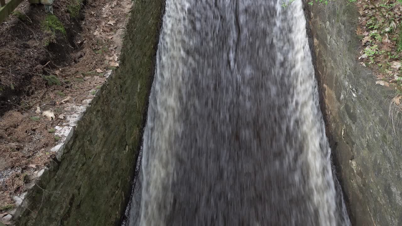 A high-flowing water current runs continuously along a concrete ramp without stopping. It offers a beautiful perspective!
