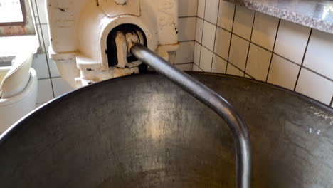 view of an old traditional machine for bread making - close up, tilt-up shot