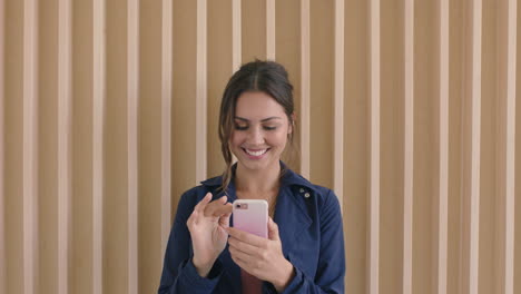portrait-of-beautiful-young-brunette-woman-smiling-happy-enjoying-texting-browsing-using-smartphone-mobile-technology