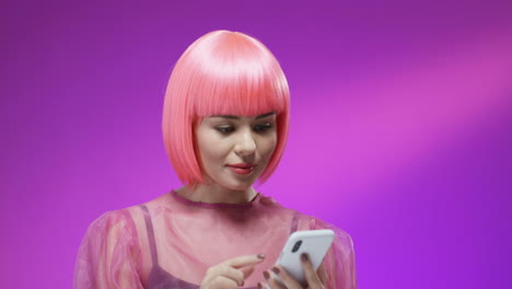 close up of happy woman wearing a pink wig