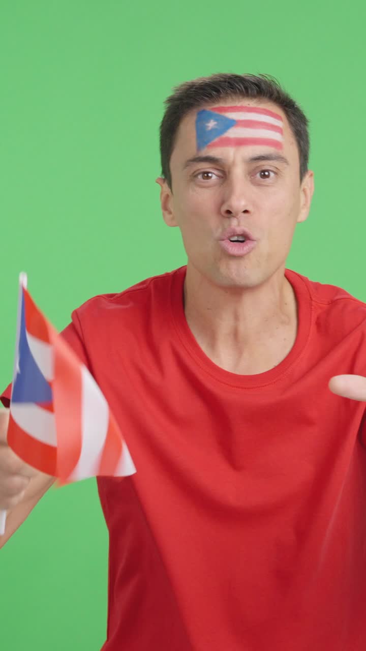 Man cheering for Puerto Rico screaming and waving a national flag