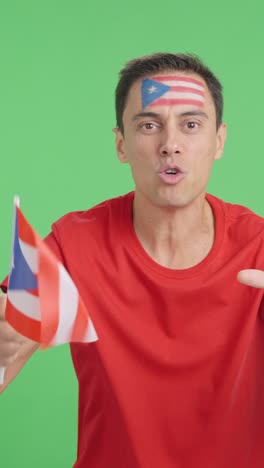 man cheering for puerto rico screaming and waving a national flag
