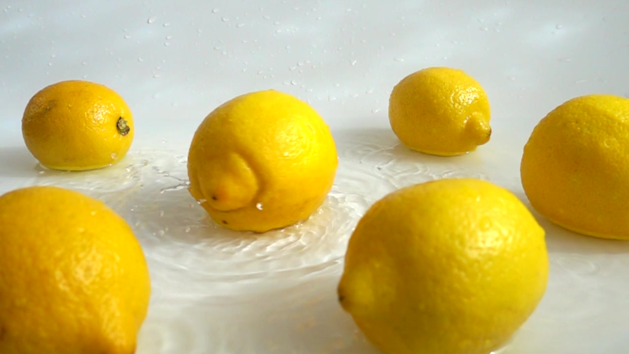 Lavaggio di limoni in acqua. Movimento rallentato