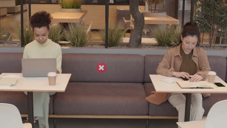 women working on safe distance in restaurant