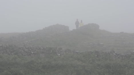 People-Emerging-from-Fog-and-Walking-Along-Hiking-Path-of-a-Cloudy-Day