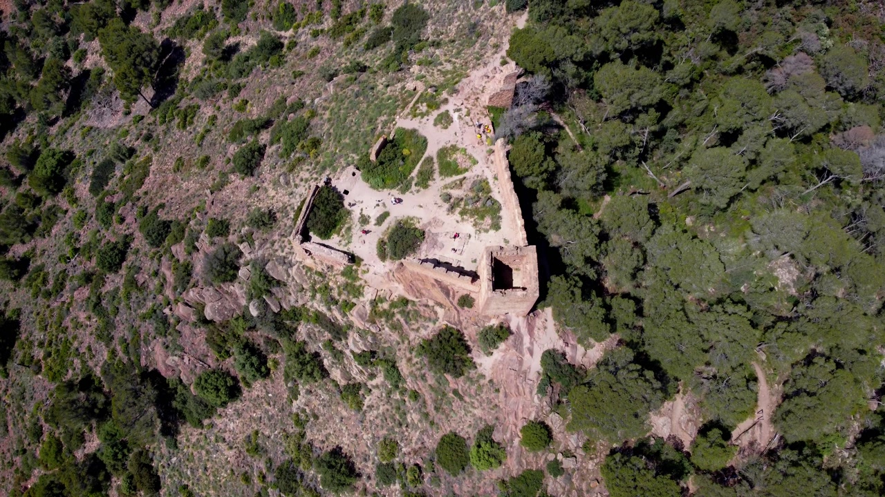4K drone overhead view of medieval castle in Valencia, Spain, showing mountaintop fortress and surrounding slopes in cinematic aerial shot
