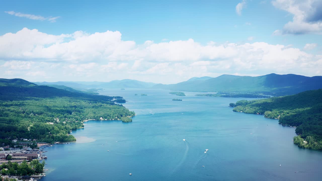 호수 조지 (lake george) 위에서 여러 배가 물 위에서 경주하고 있습니다.