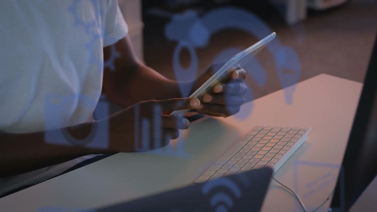 Person Using Digital Tablet with Animated Technology Icons at Desk