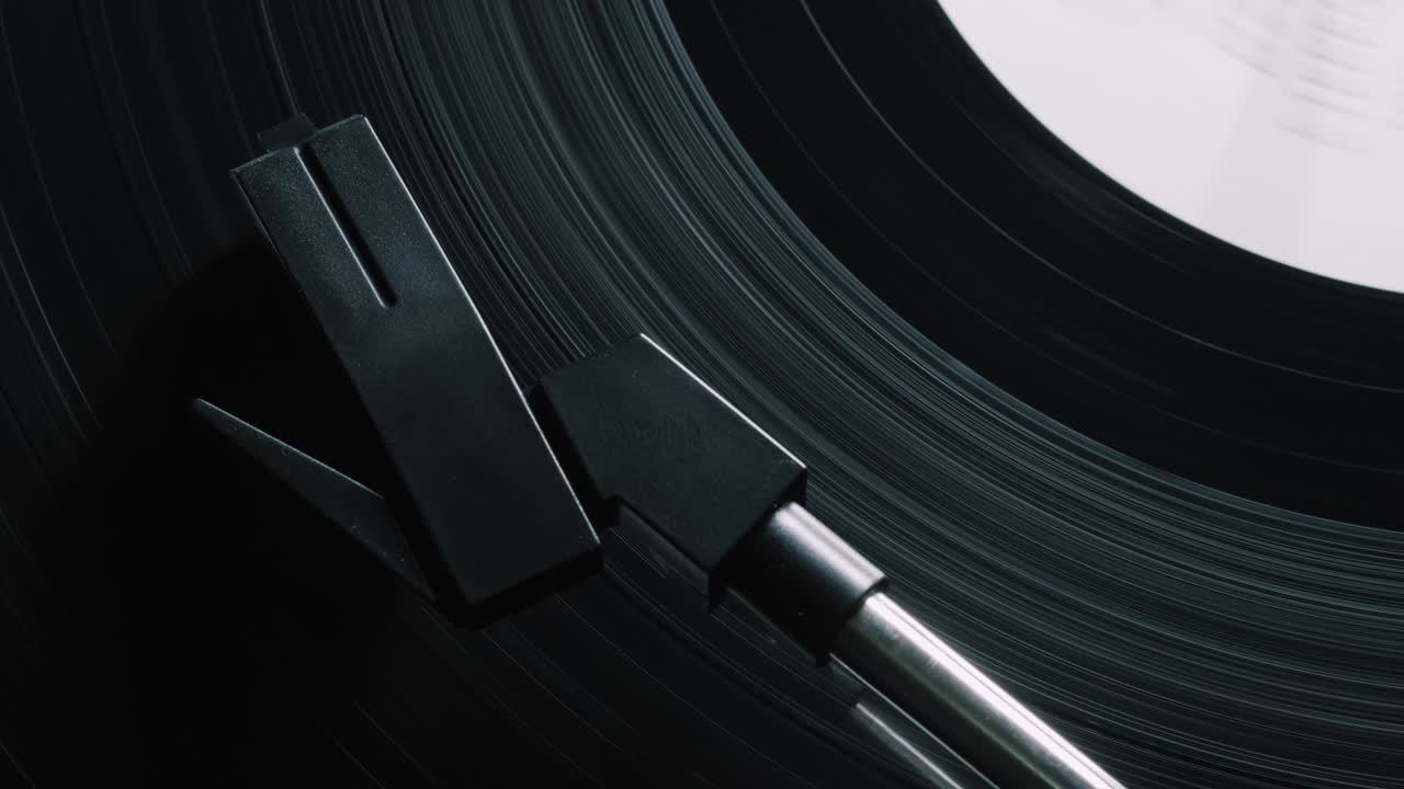 Vinyl record on turntable, viewed from above. Close-up. Pick-up lifts off. 4k