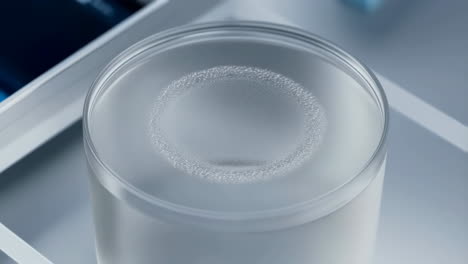 glass of water with effervescent bubbles on the surface