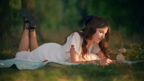 girl writing golden thoughts during summer picnic