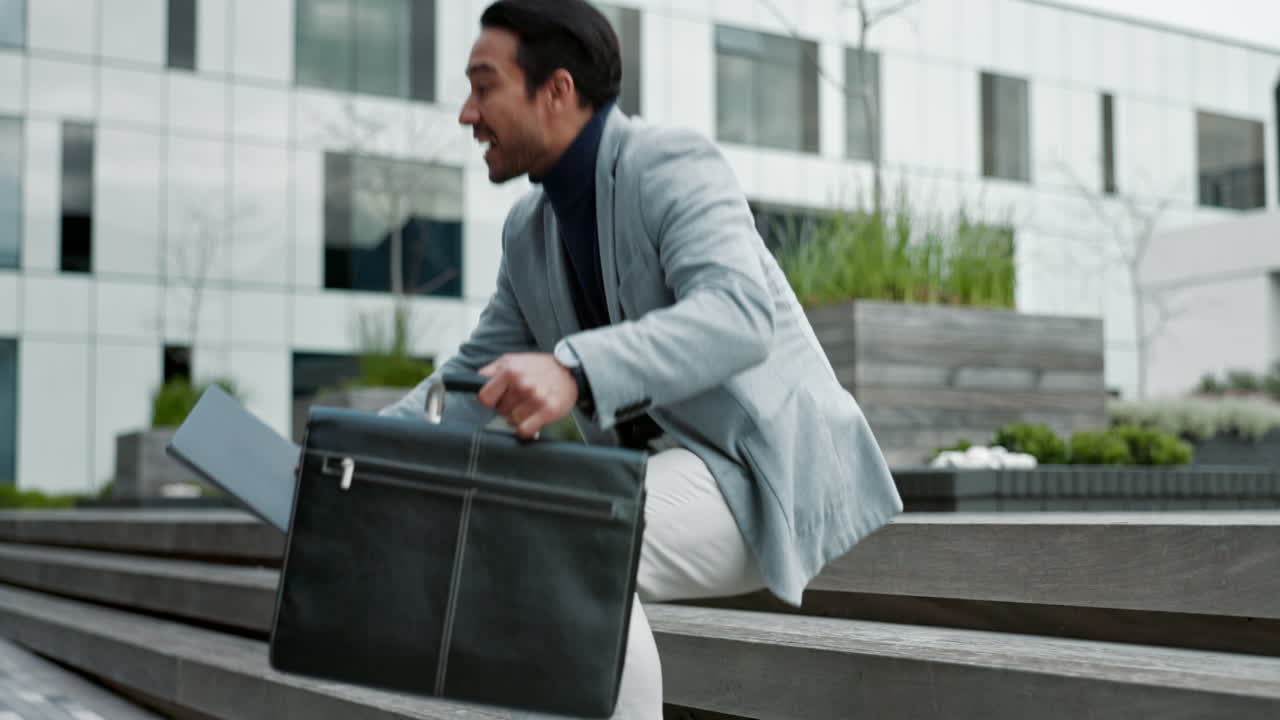 A businessman walks towards his office building, looking confident and successful.