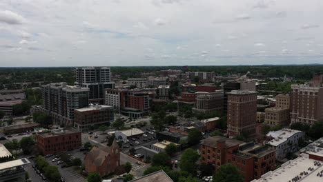 aerial shot over the buildings and streets of the city of greenville in south carolina