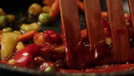 cooking vegetables with tomato sauce in a pan