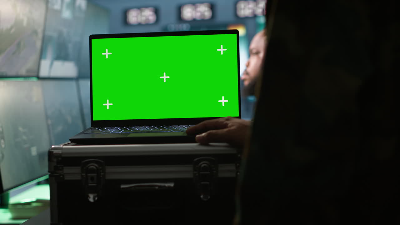 Intelligence corps expert controlling drones with mockup notebook