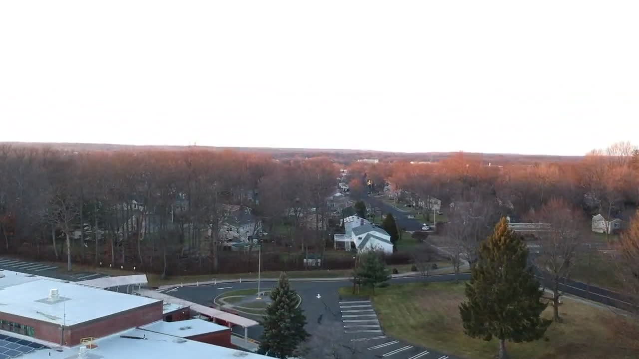 Drone over a building in a neighborhood
