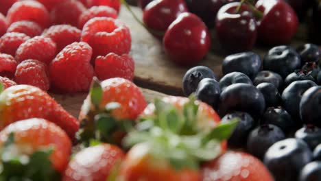 various berry fruits on wooden table 4k