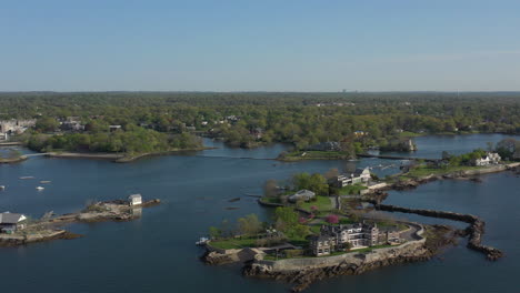 An-aerial-view-over-small-islands-with-large-houses-surrounded-by-greenery-on-a-sunny-day