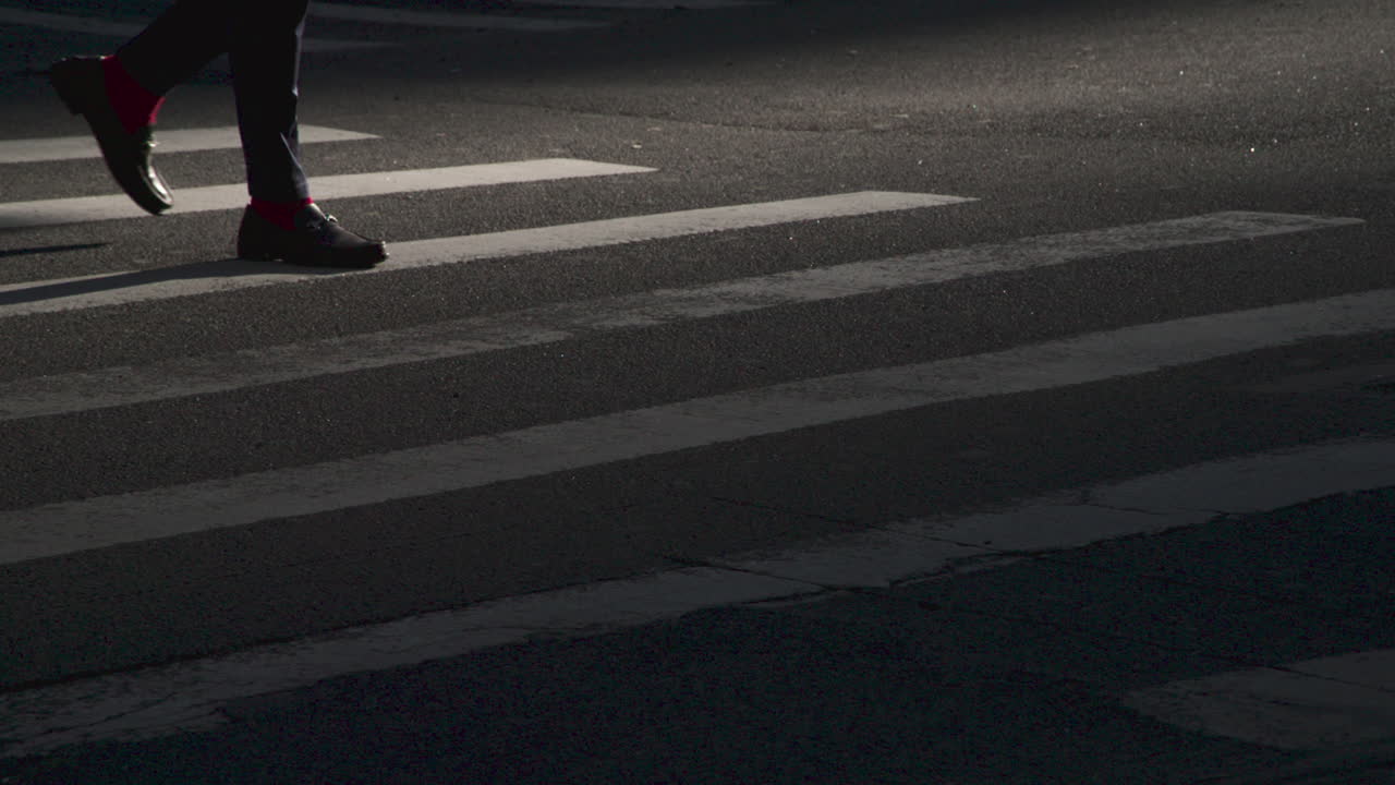 Slow motion shot of feet in a city crosswalk. Shot at sunrise in Manhattan
