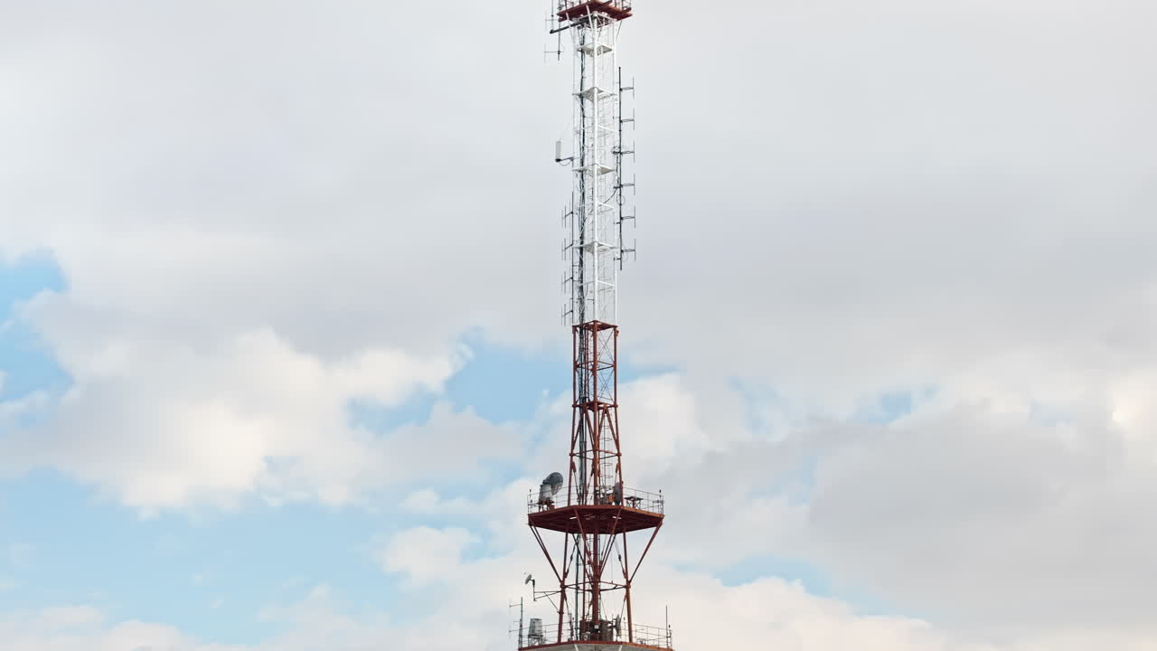 Aerial drone view of the radio transmission tower in the daylight