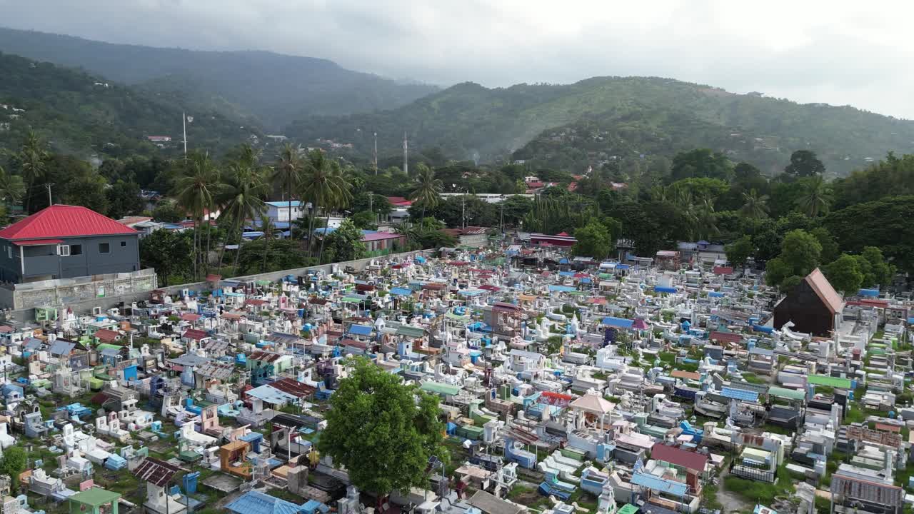 Aerial perspective of tombs in a colorful and compact cemetery in Dili. Santa Cruz Cemetery