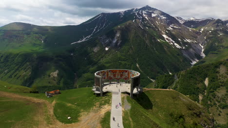 cinematic revealing drone shot of the arch of friendship of peoples in gudauri georgia