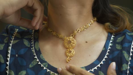 closeup of neck with designer gold necklace, 18k huid certified gold necklace, closeup