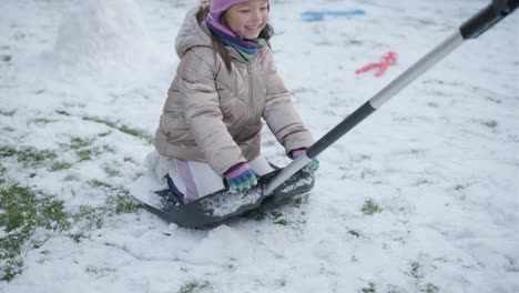 grandfather and granddaughter having fun in the snow