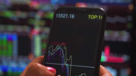 mobile stock market trading app, investor, trader or broker using crypto exchange platform app on smartphone analyse market chart investing money in financial on mobile screen with cell phone in hands