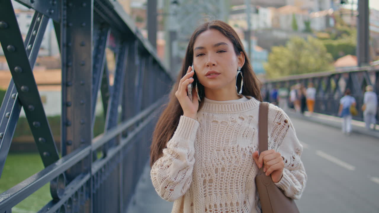Poised lady calling smartphone strolling iron construction bridge place closeup