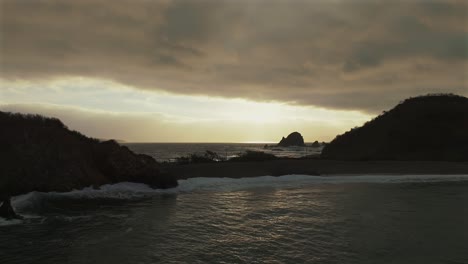 clouded sky over playa la morita during sunset in tenacatita, jalisco, mexico. aerial wide shot