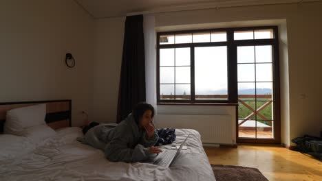 woman working on laptop in a mountain hotel room