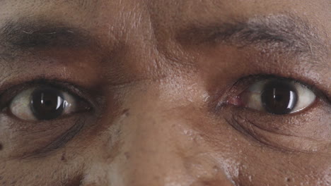 close up mature black man eyes opening looking surprised amazed expression