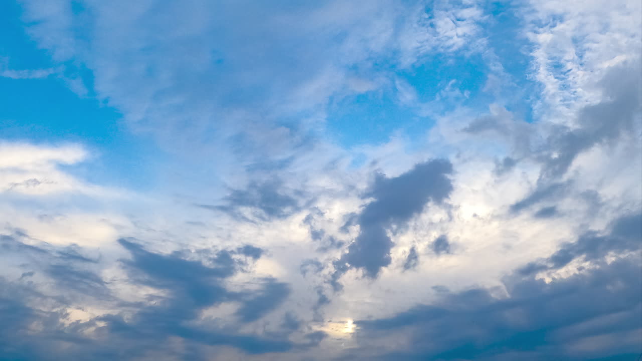 Fantastic beautiful clouds transforming quickly. Accumulating cloudscape in the bright blue skies. Timelapse.