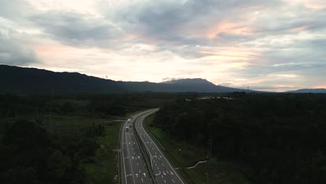sunset drone view evening at pan borneo highway with green forest and mountain,sarawak.