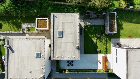 a cinematic drone shot of the rooftops and gardens of luxurious small villas - dji mavic 3