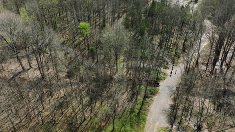 people enjoying trail through forest trees in bell slough wildlife management area, arkansas