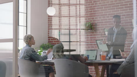 young african american businessman using digital tablet computer presenting financial graph data showing colleagues in office presentation diverse team collaborating brainstorming strategy