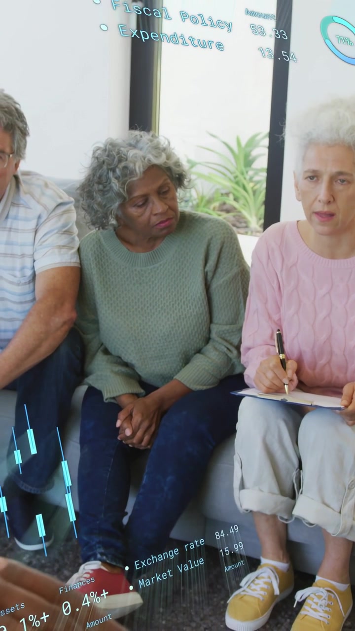Vertical video: Team of three, right woman writing, camera zooming out causing charts for finance
