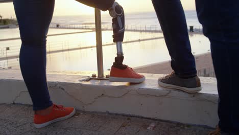 Low-section-of-couple-standing-at-promenade-near-railing-4k