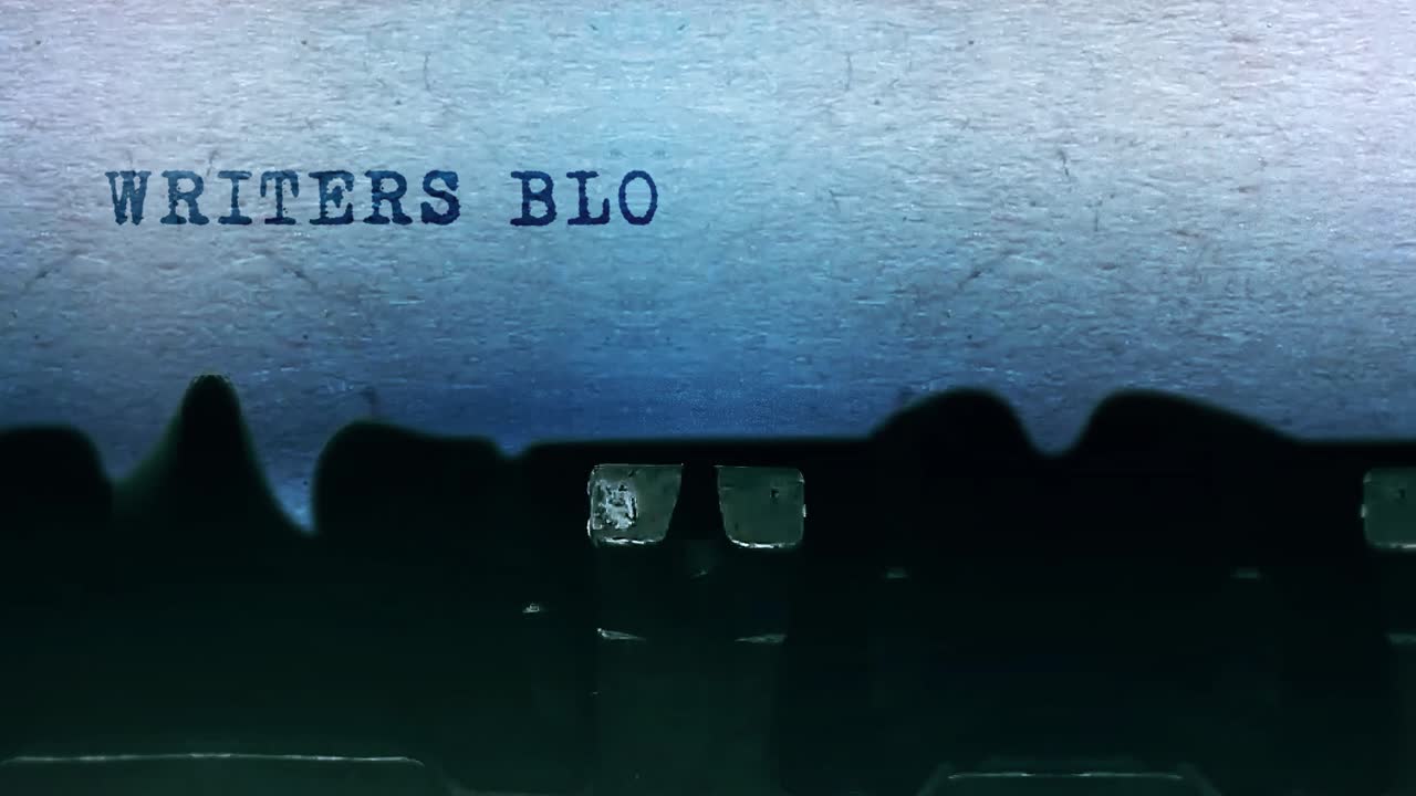 Writers block word closeup being typing and centered on a sheet of paper on old vintage typewriter