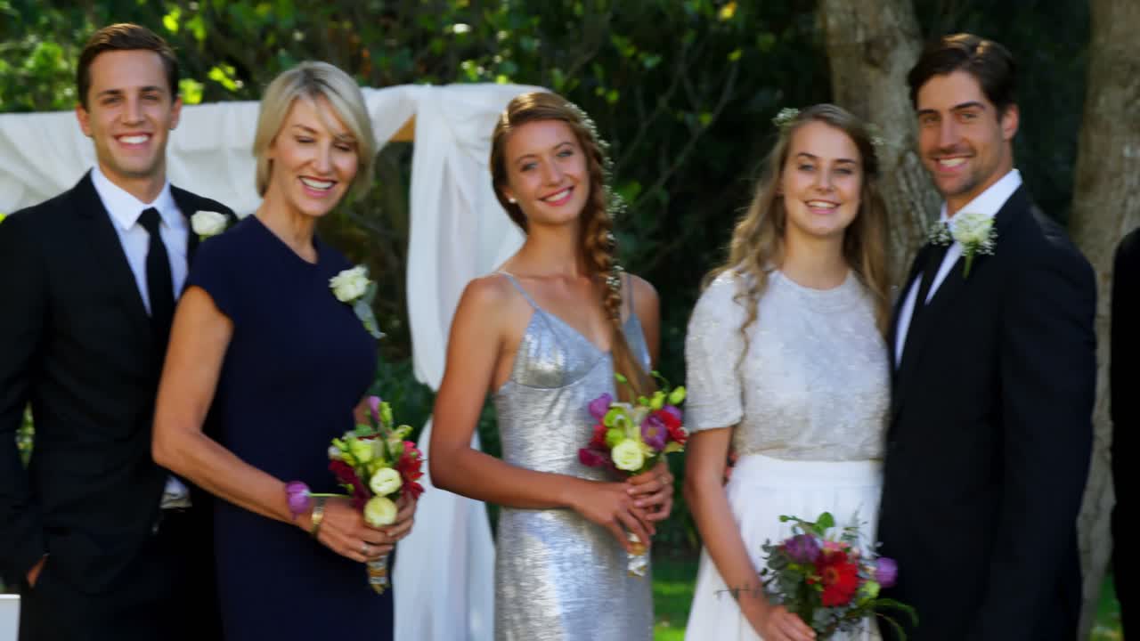 Happy young bride and groom pose with family and friends 4K 4k