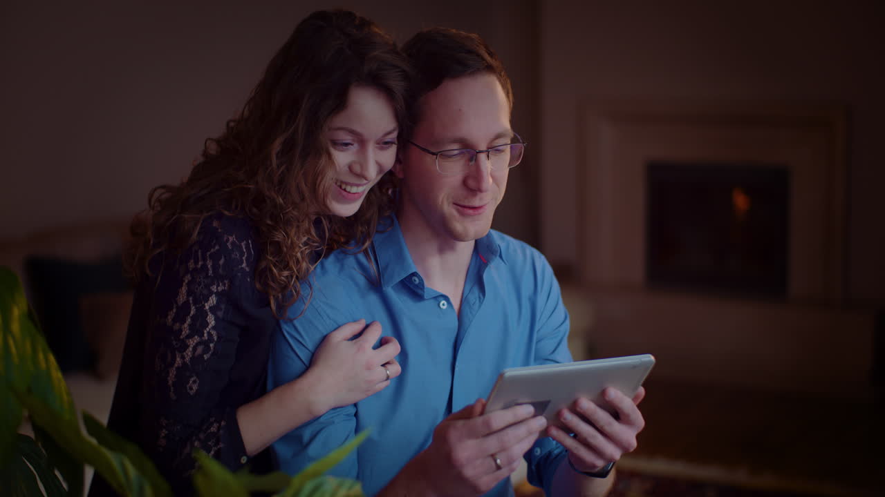 Couple looking at tablet together at home