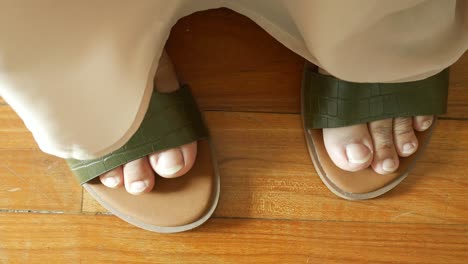 close up of girls feet wearing sandal indoor