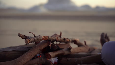 adventure outdoor camping in the wild african egypt desert, local beduin light up fire wood
