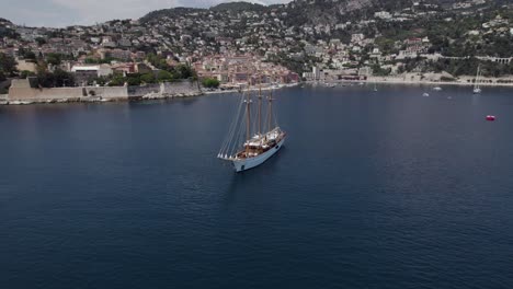 Luxury-Barque,-Triple-Masted-Yacht-on-French-Riviera-Coastline,-Aerial-Orbit