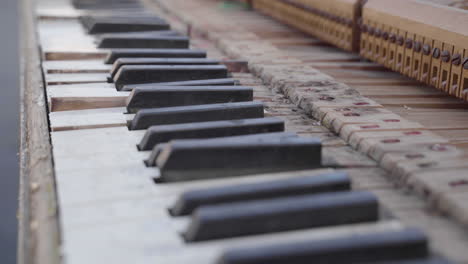 closeup of old broken upright piano keys