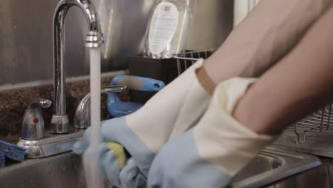 Squeezing-The-Soapy-Sponge-And-Rinsing-It-With-Water---Close-Up-Shot